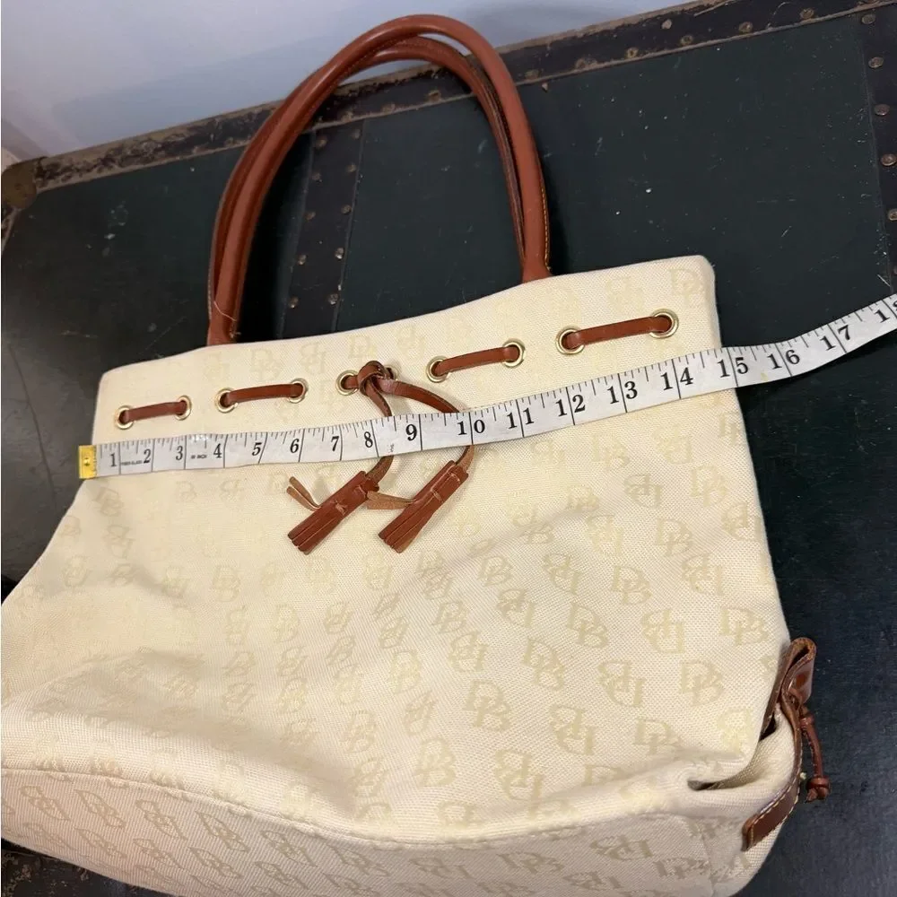 Dooney and Bourke Beige Canvas and Leather Signature Tassel Tote Handbag